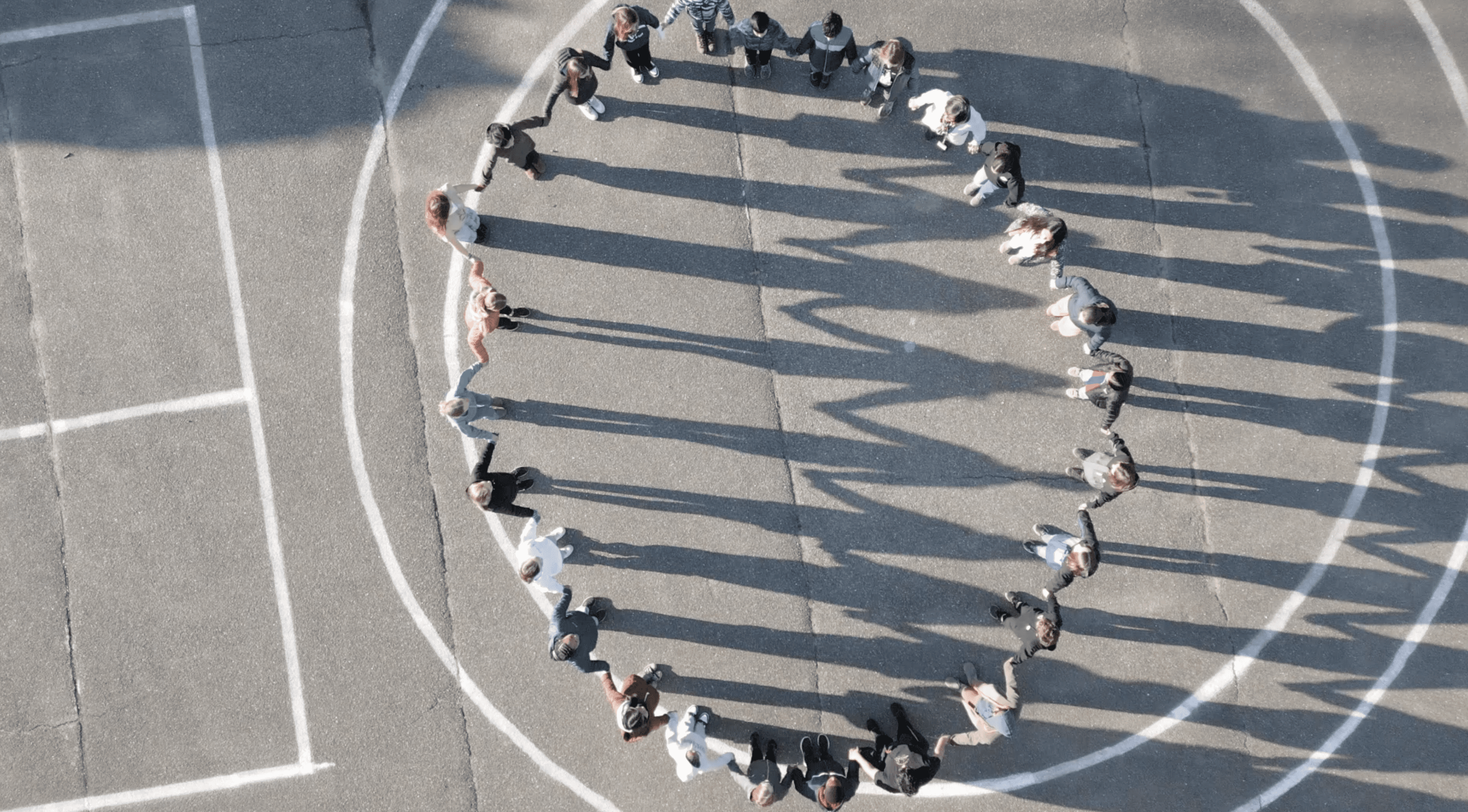 Children dancing on the blacktop, drone view
